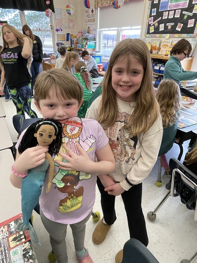 Pictures of students participating in buddy day and working on st patrick day crafts. 