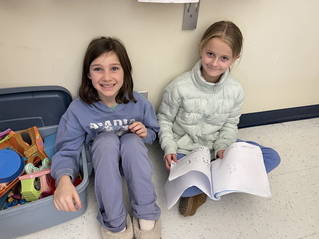 Pictures of students participating in buddy day and working on st patrick day crafts. 