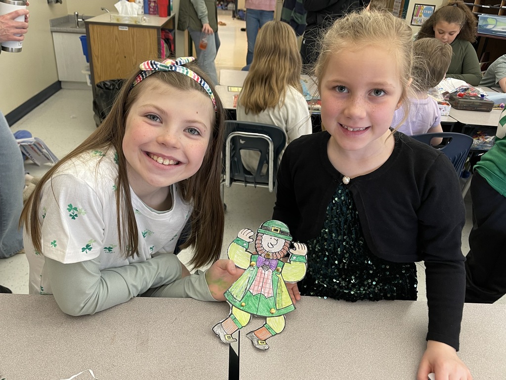 Pictures of students participating in buddy day and working on st patrick day crafts. 