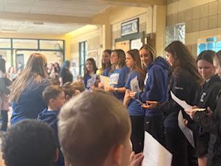 Pictures of students visiting the girls high school basketball team and celebrating their victory. 