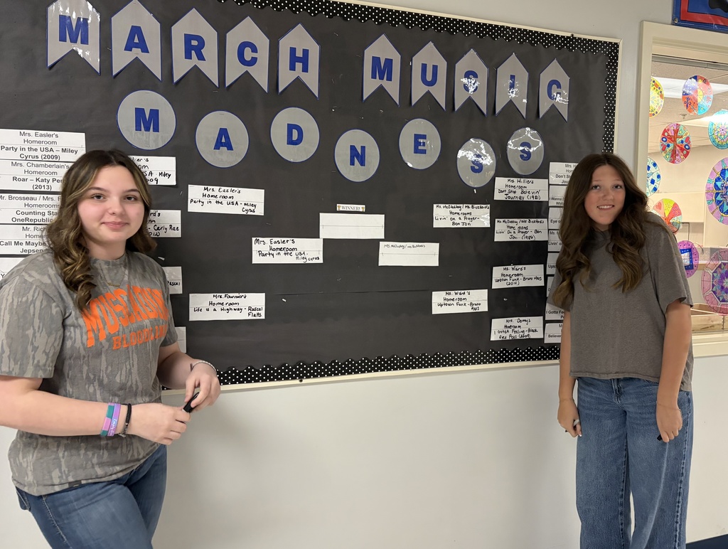 Students in front of the marc madness music bracket.