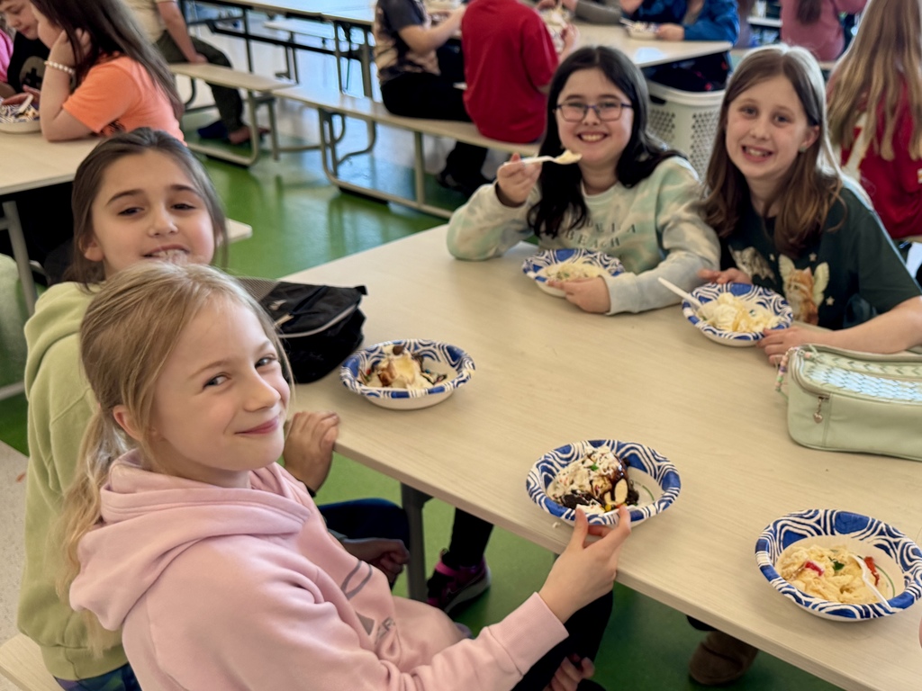 fourth graders enjoying a ice cream sundae party after winning our March attendance competition