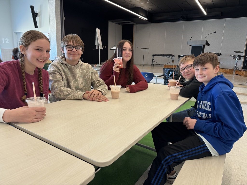 fourth graders enjoying a ice cream sundae party after winning our March attendance competition