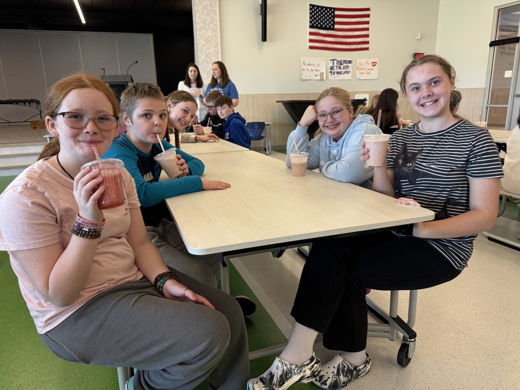 fourth graders enjoying a ice cream sundae party after winning our March attendance competition
