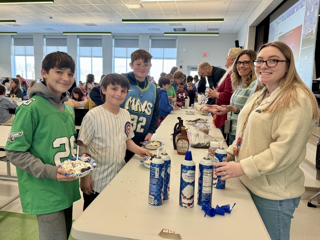 fourth graders enjoying a ice cream sundae party after winning our March attendance competition