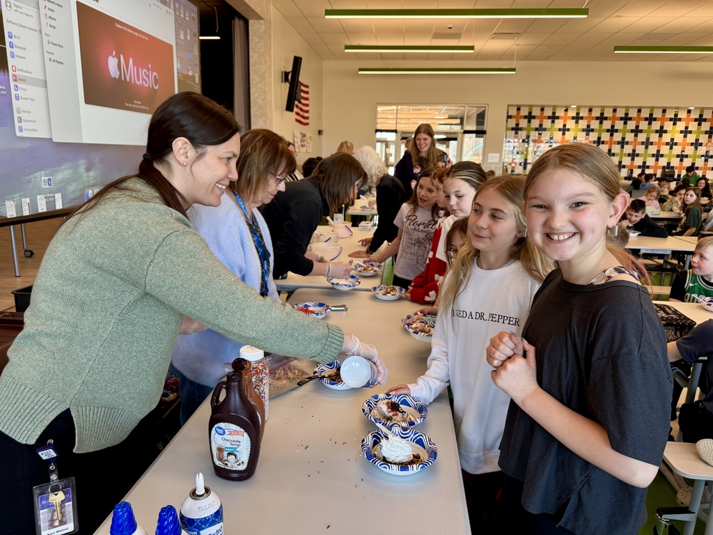 fourth graders enjoying a ice cream sundae party after winning our March attendance competition