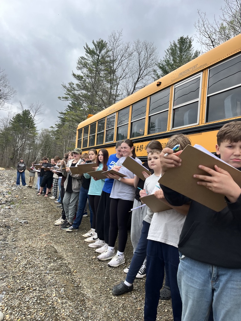 students at a bridge learning about engineering and design.