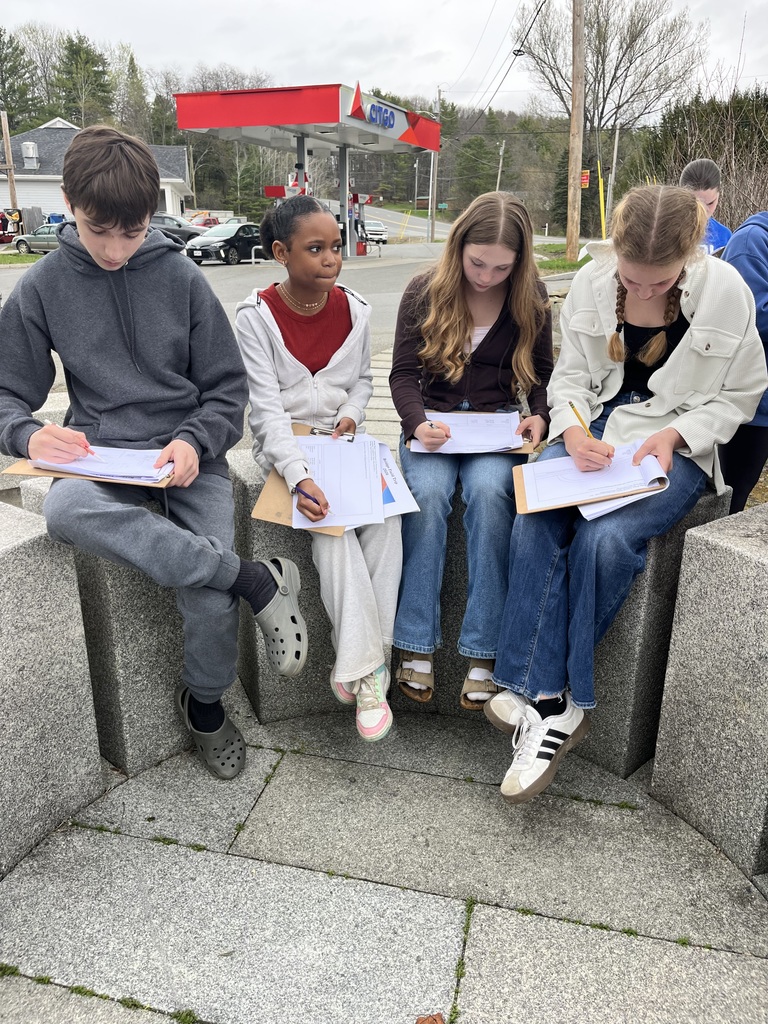 students at a bridge learning about engineering and design.
