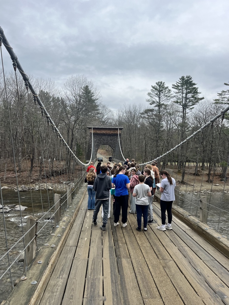 students at a bridge learning about engineering and design.