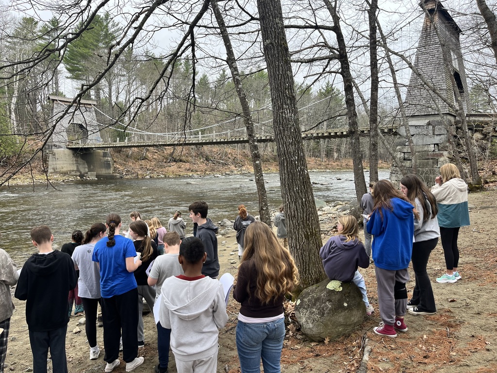students at a bridge learning about engineering and design.