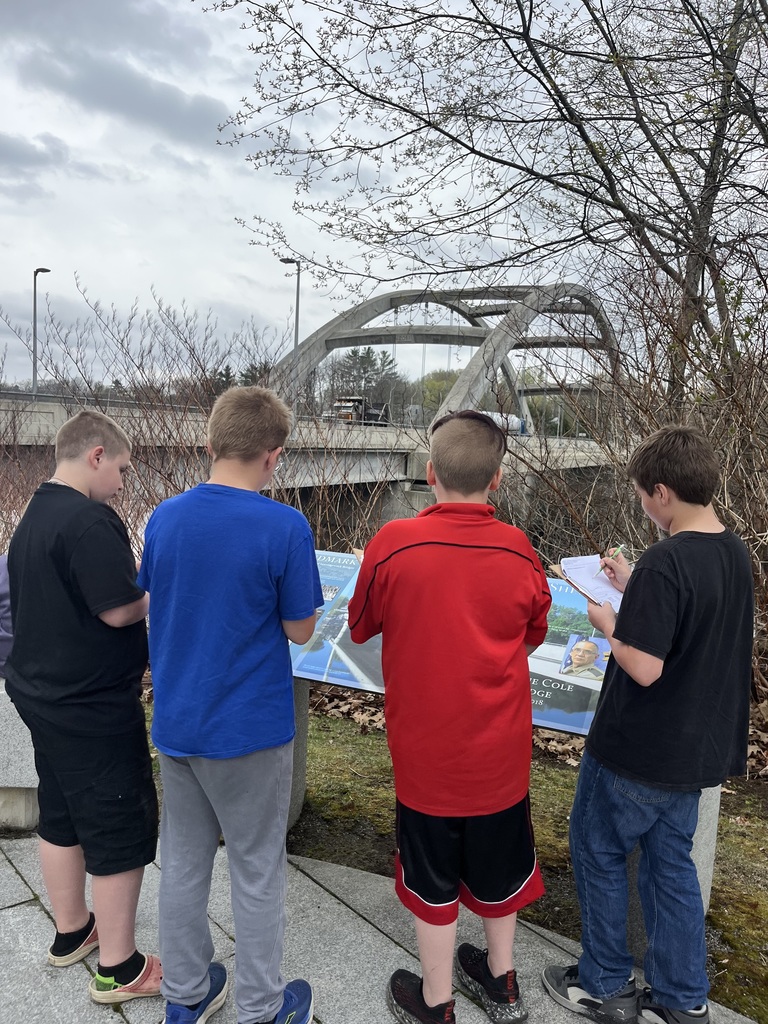 students at a bridge learning about engineering and design.