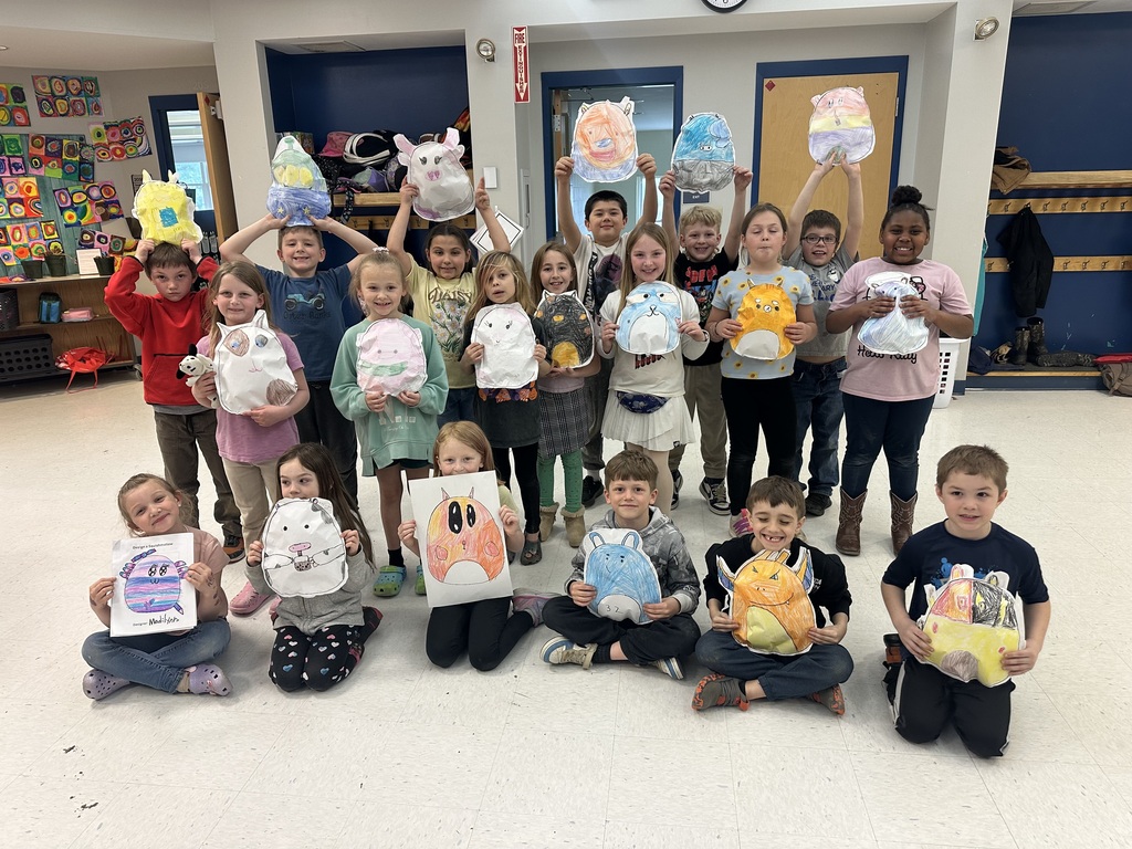 students taking a picture with their Squishmallow artwork.