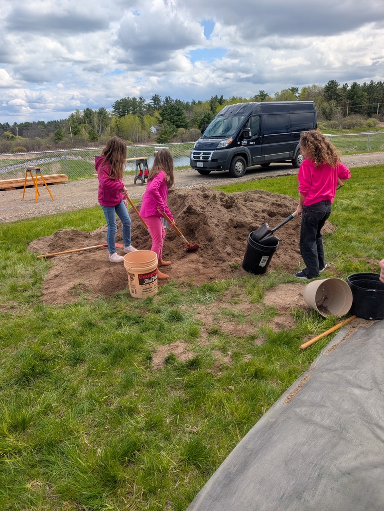 students learning how to build raised gardens.