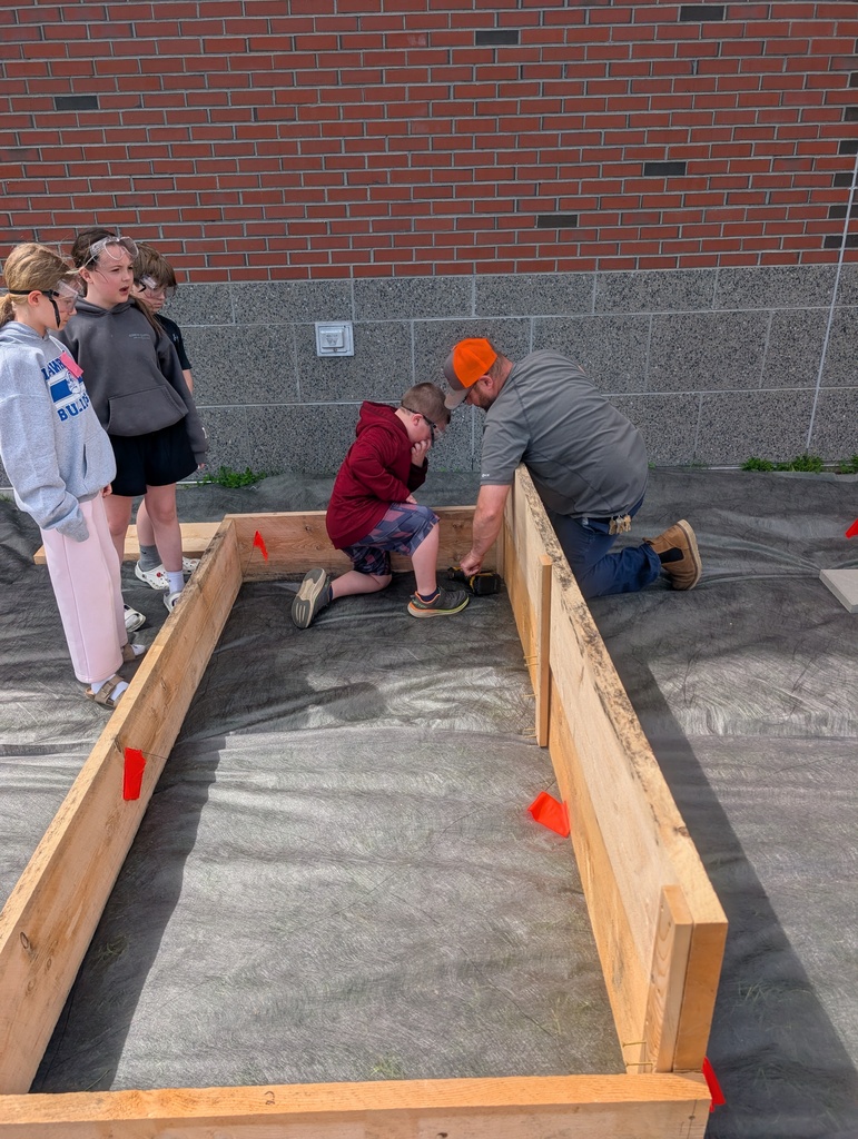 students learning how to build raised gardens.