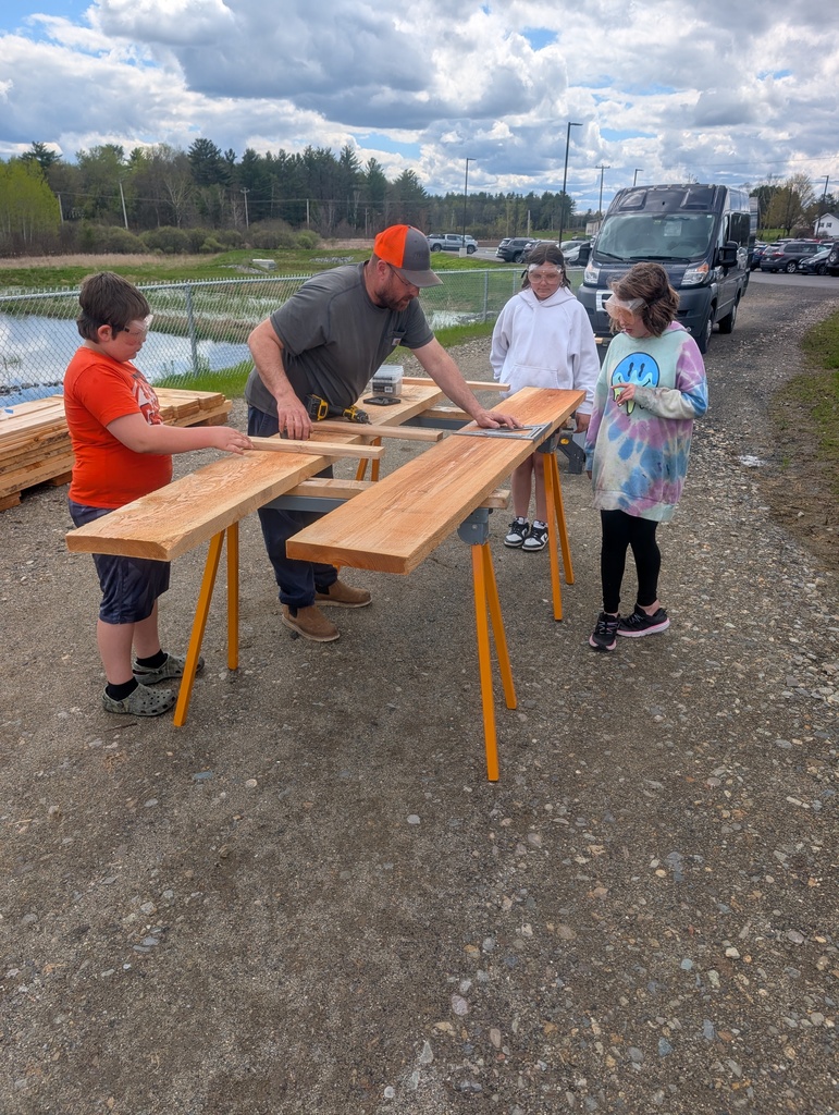 students learning how to build raised gardens.
