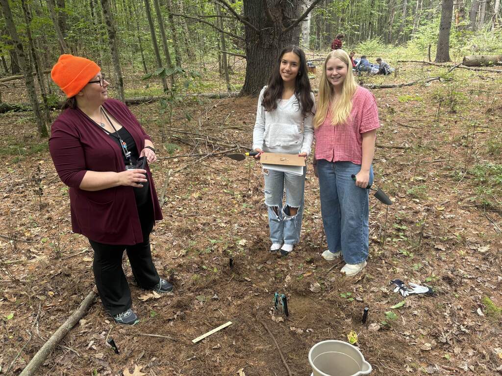 Mrs. Davis working wit Archaeology students Avery and Paige
