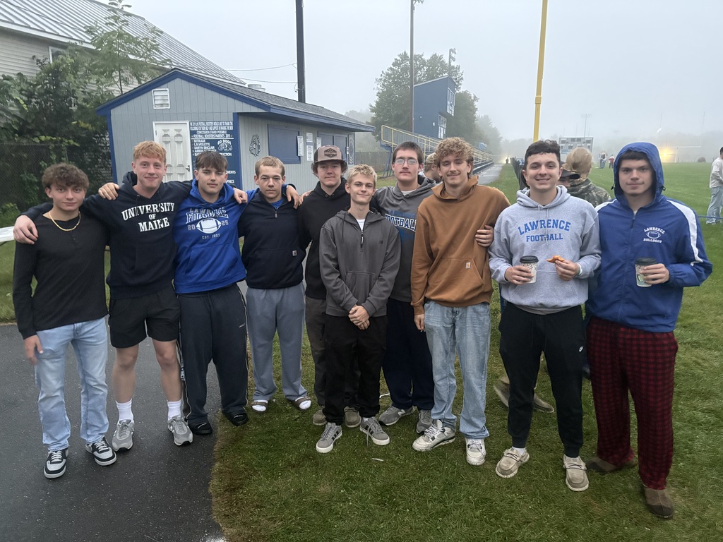 Senior boys standing together at sunrise on the football field