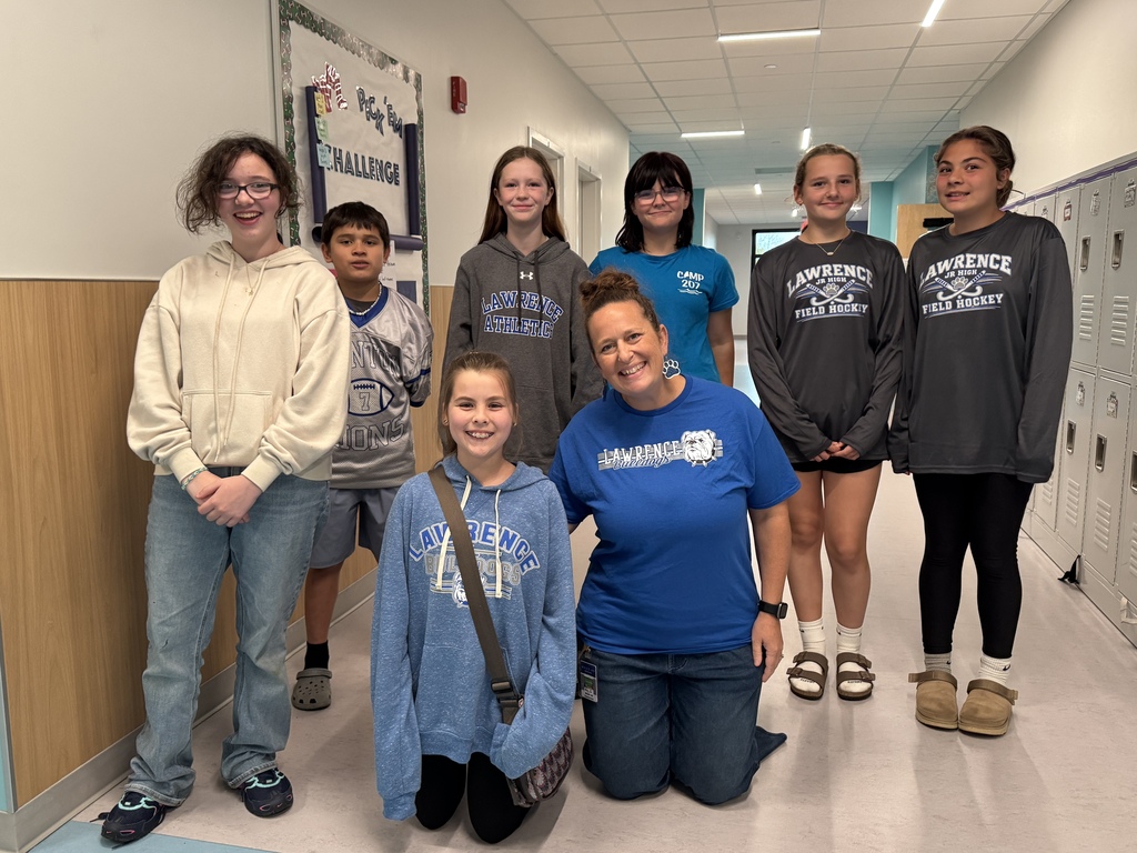 Six students stand while two kneel in the foreground showing their Lawrence Bulldogs apparel.