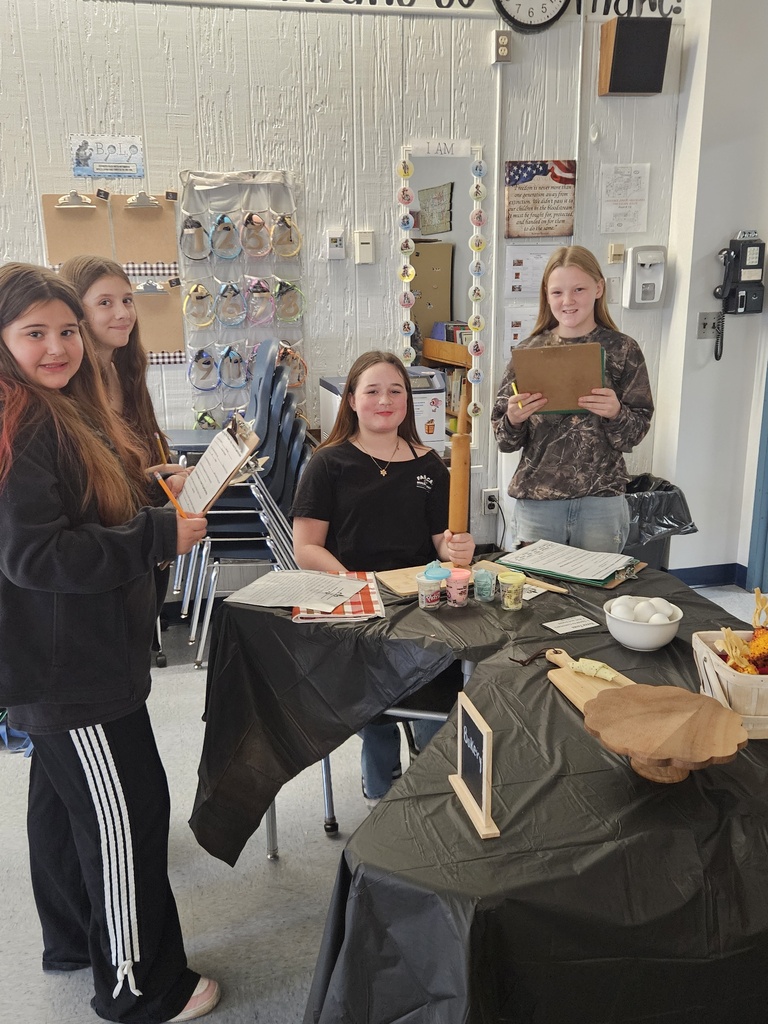 7th Grade Social Studies - learning about the Middle Colonies. Four female students work on a project together.