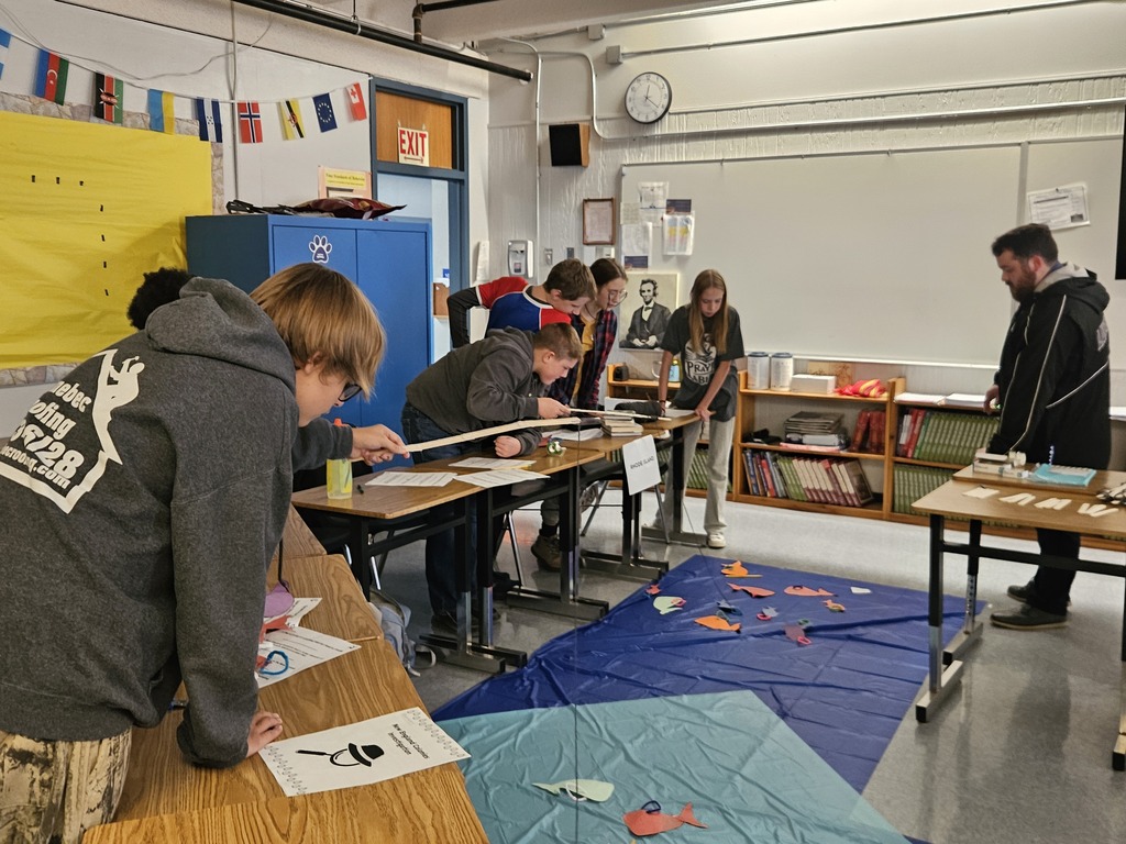 7th Grade Social Studies - learning about the Middle Colonies. A mixed goupe of students work on a project as a group.