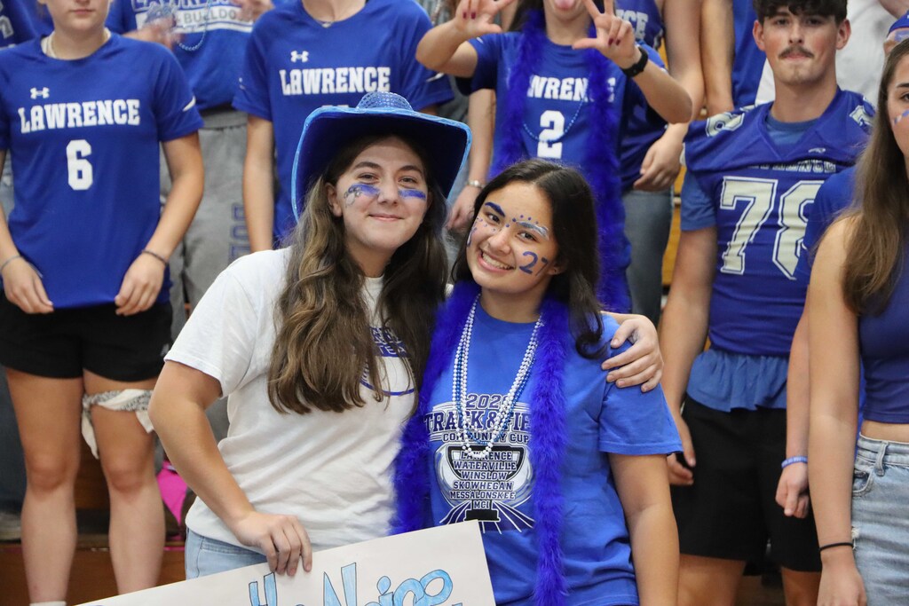Two students wearing Bulldogs attire smiling at the pep rally.