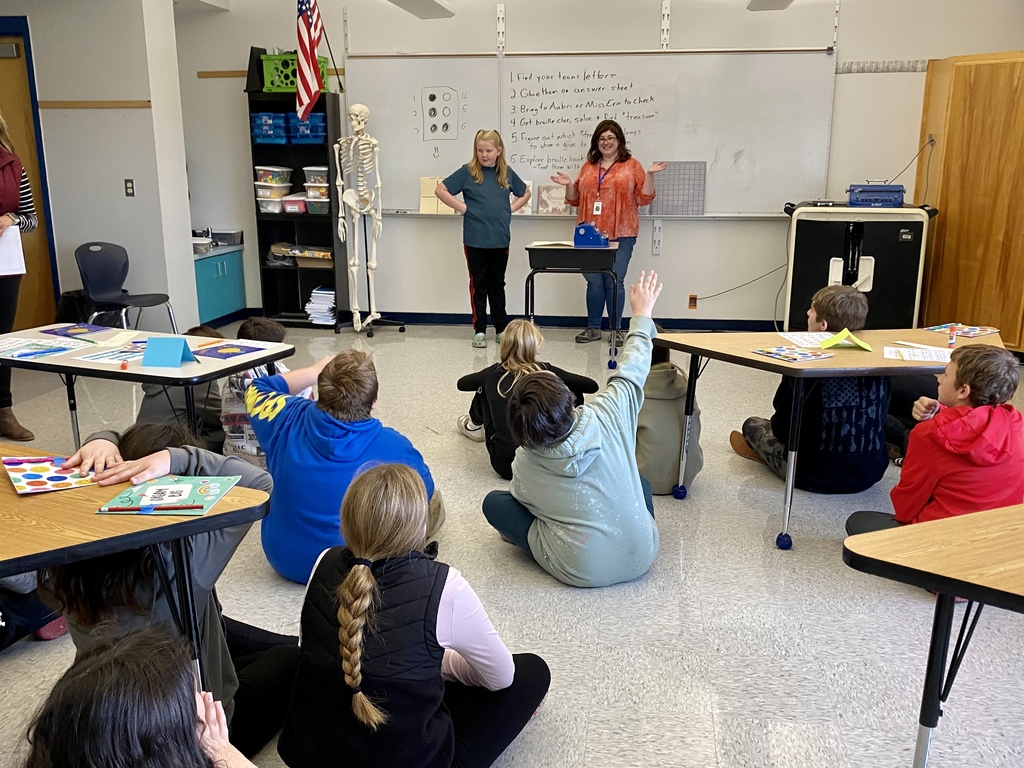 Students involved in activities associated with learning to read brail.