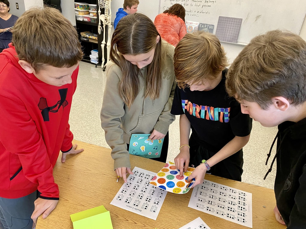 Students involved in activities associated with learning to read brail.