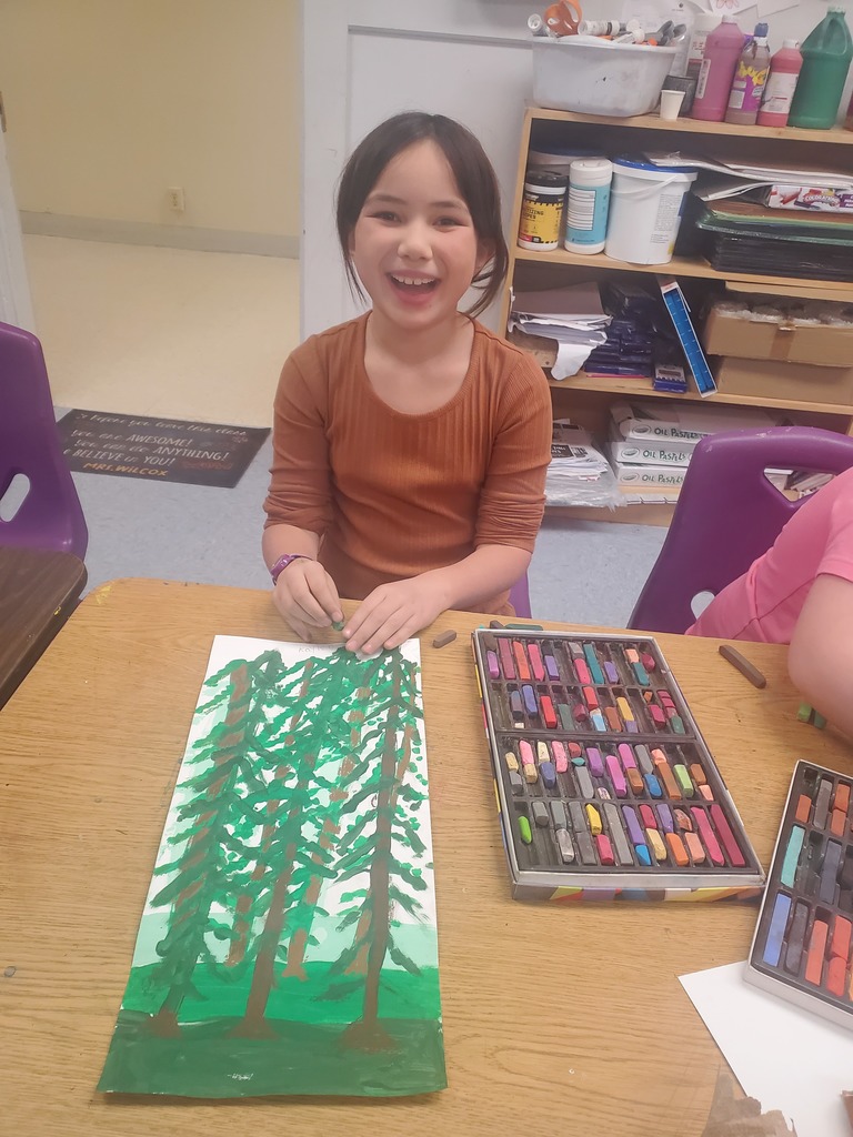 Pictures of third graders working on art projects.