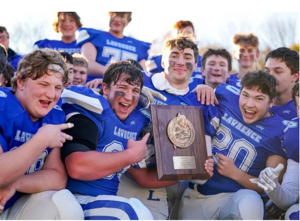 members of the lawrence high school football team posing for a picture.