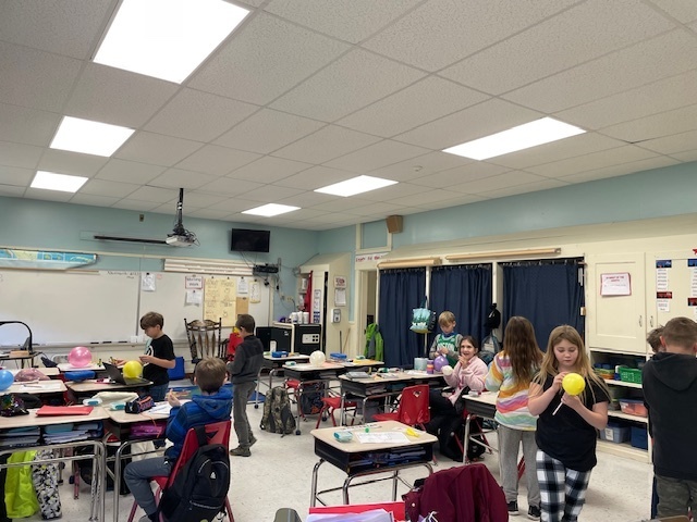 students working on balloon projects.