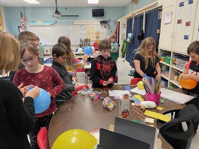 students working on balloon projects.