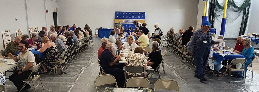 Over 80 turned out for this years banquet. This photo show the group seated in the old gym at banquet tables eating and visiting.