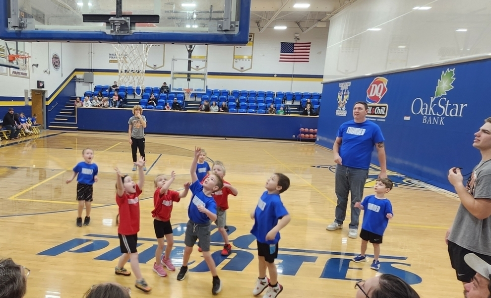 Preschool student playing basketball 