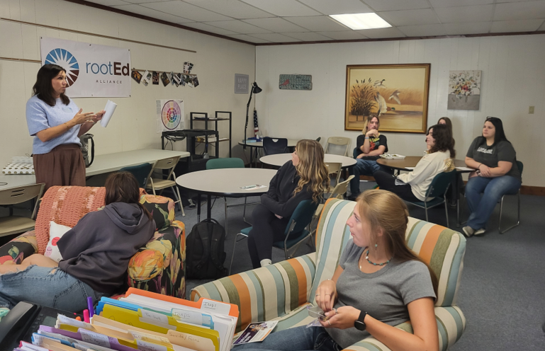 In this image, seniors meet with an represenative from State Fair Community College during a lunch and learn time in our rootEd advisors office.