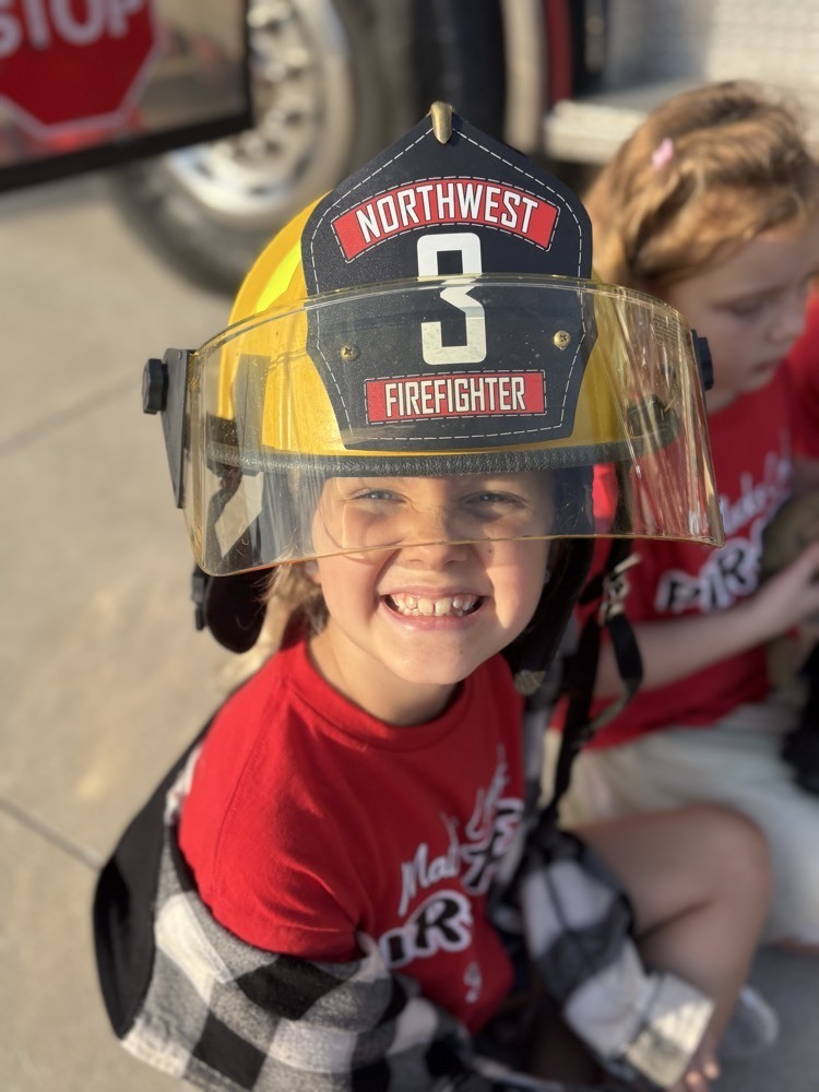 Kid with firefighter hat on