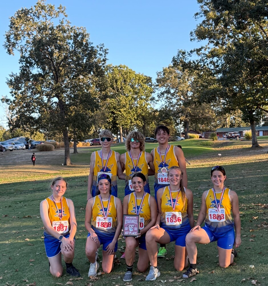 Karsyn, Carter and Sebastian pose with Kelsie, Allie, Izzy, Bailey and Kaelee after the Dixon Invite. All 8 have their medals and Izzy is holding the girls' championship plaque. 