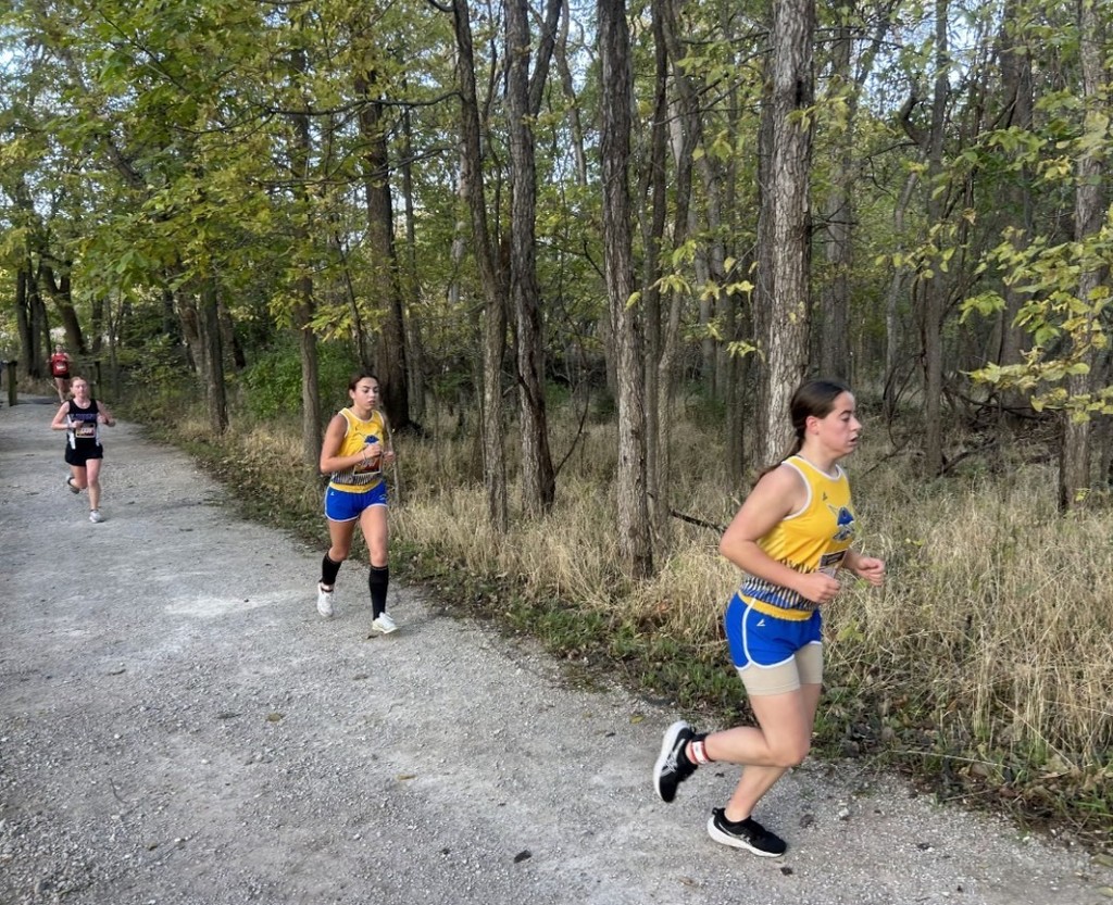 Izzy and Kaelee racing in woods
