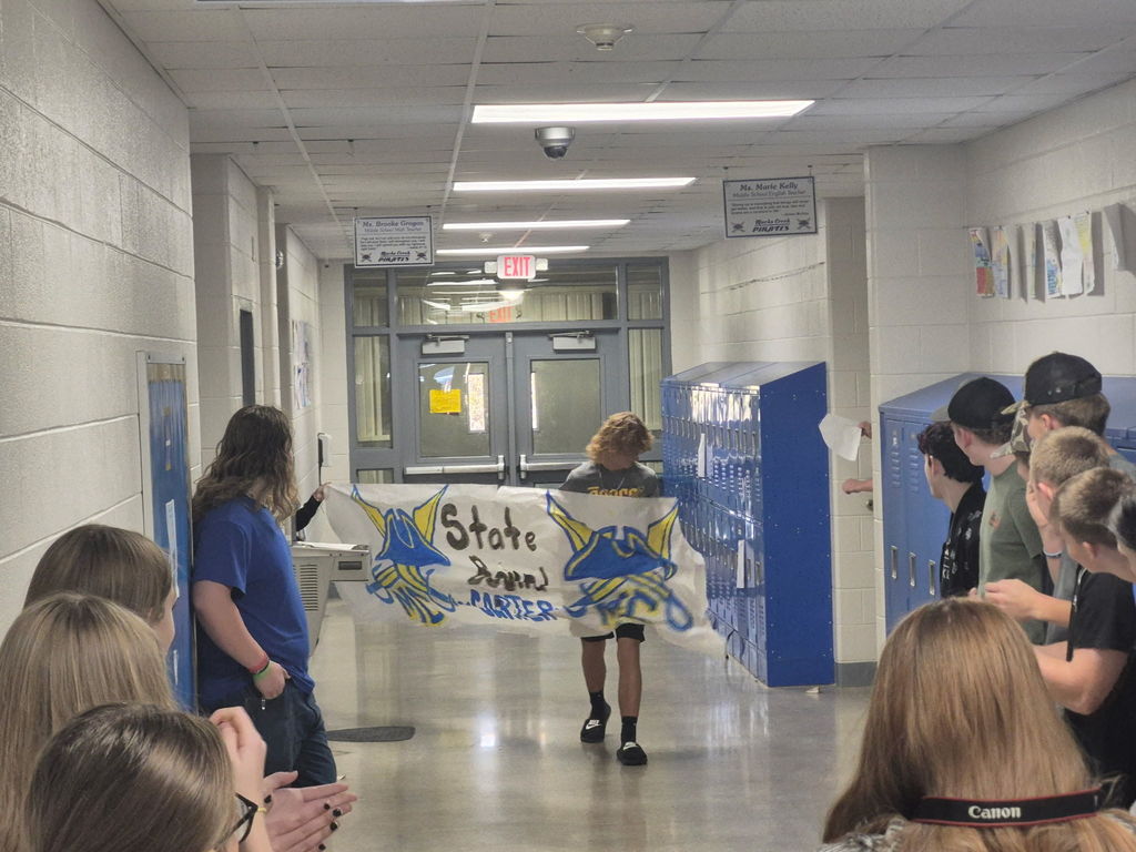 Carter breaks throught the banner before leaving for State