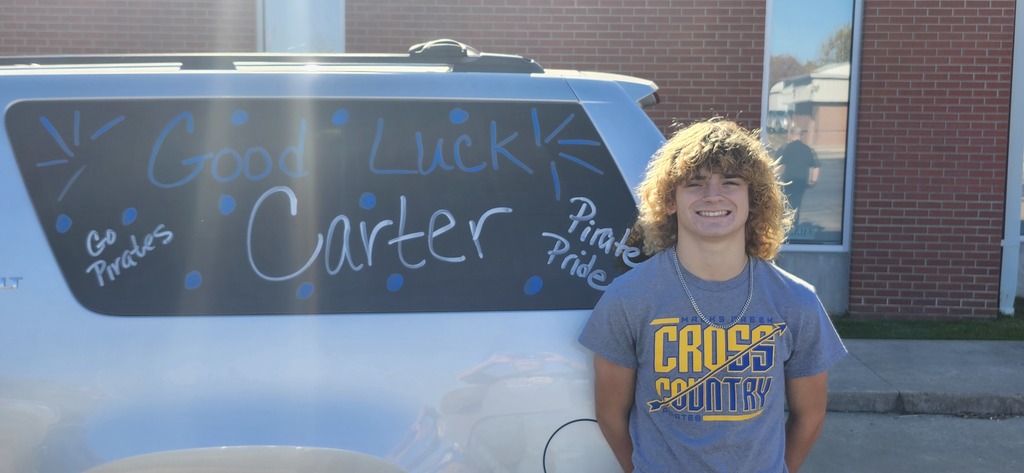Carter stands beside the SUV before leaving for State