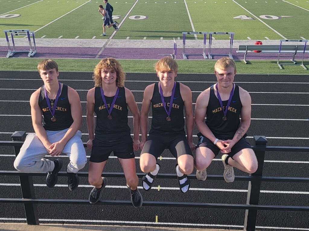 The boys 4 x 200m team poses for a photo 