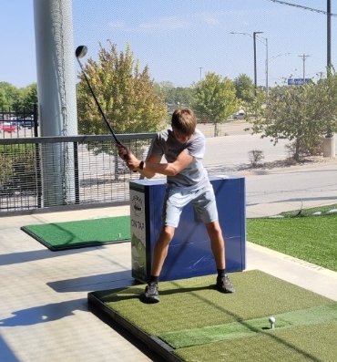 Fisher driving at Top Golf