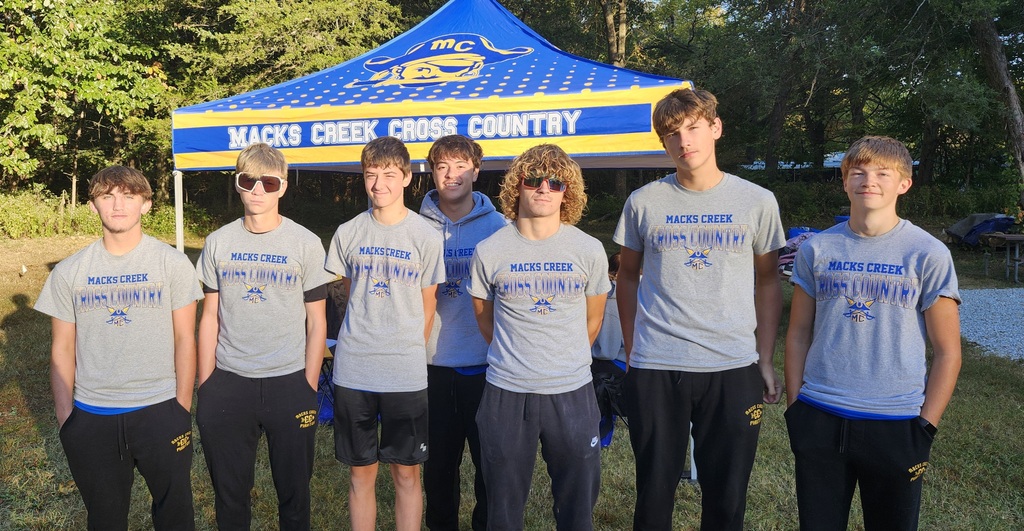 The XC team took a photo in front of their tent before heading out for a warm up.