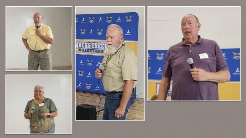 All 4 members of the Class of 1976 are pictured holding a microphone and sharing about life since graduation
