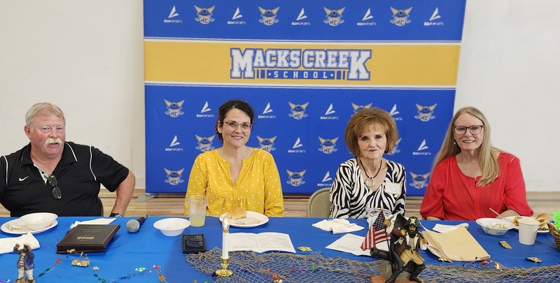 Alumni Board pose for a photo at the head table