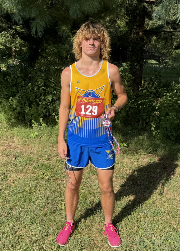 Carter takes a photo with his medal.