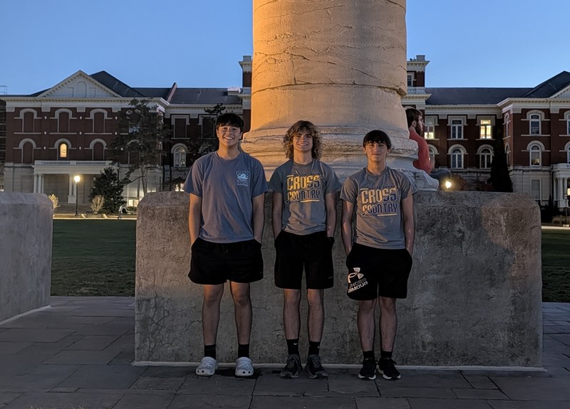 Sebastian, Carter and Parker beside one of the famous pillars at MU in the evening