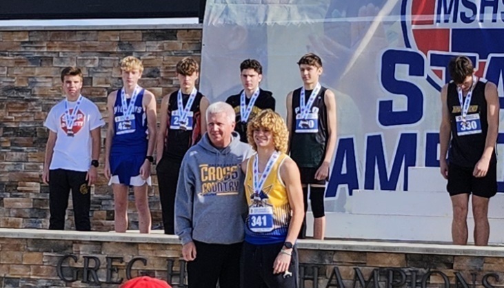 Coach and Carter pose for a photo with other medal winners in background