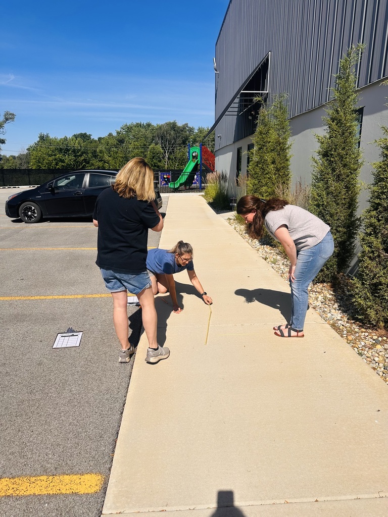 Teachers doing outdoor activity with sidewalk chalk