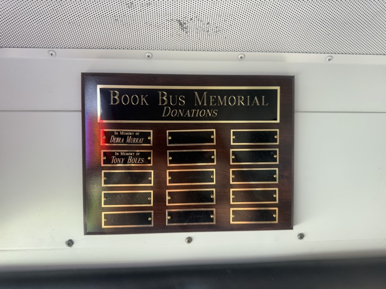 plaque inside bus with names of memorial donations
