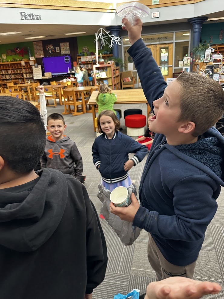 Students around a dropped egg.